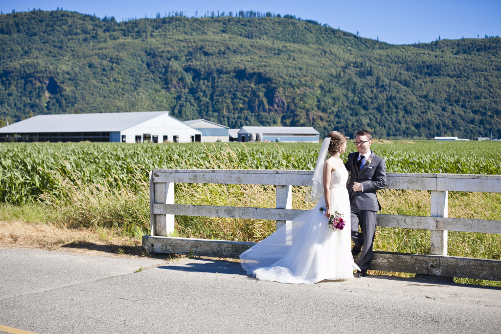 bride and groom on road with mountains