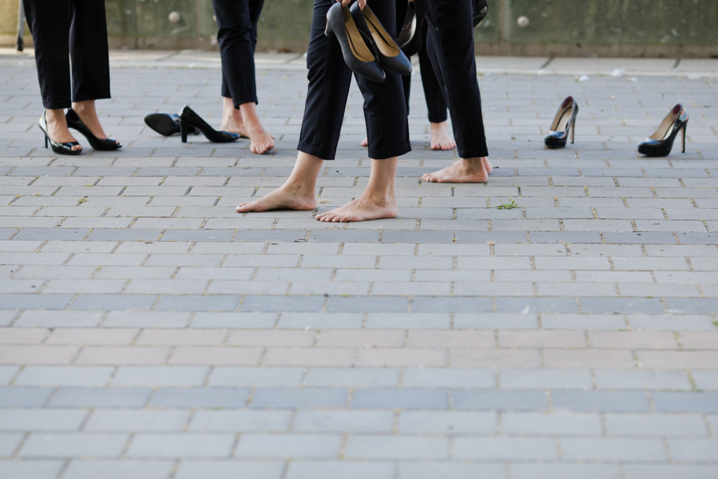 bridesmaids in suits with shoes off