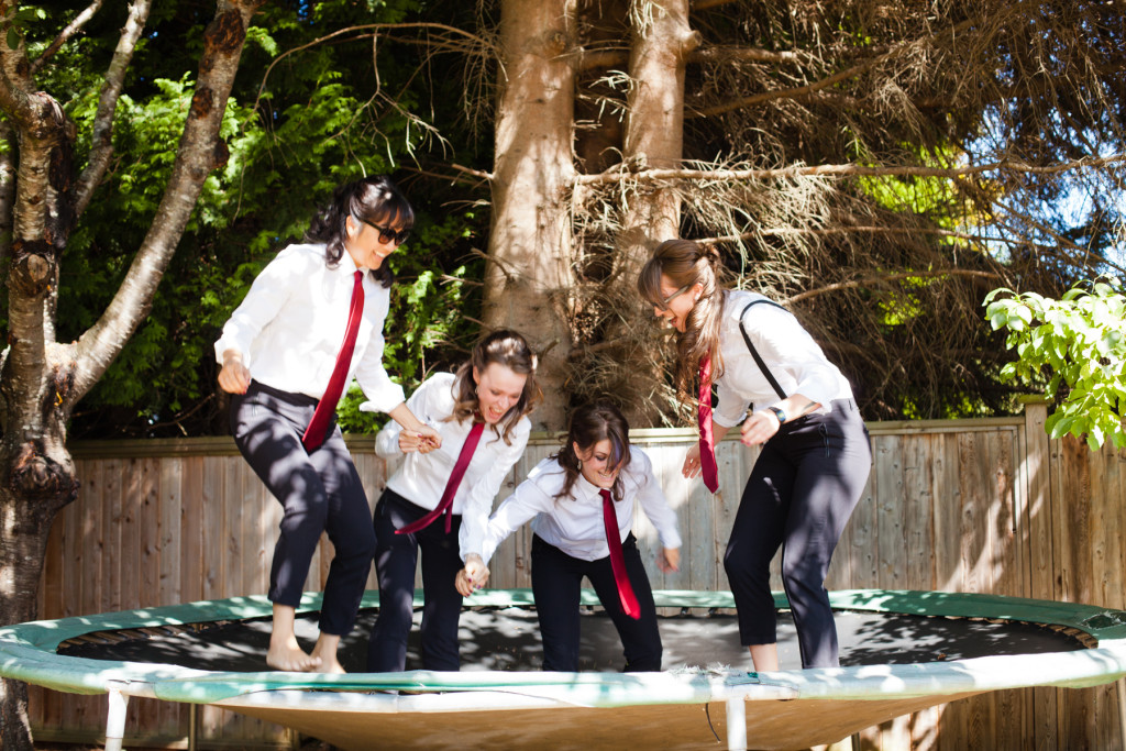 bridesmaids in suits on trampoline