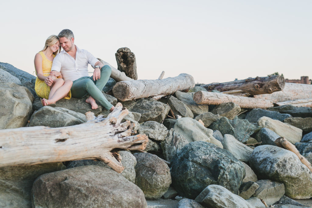 english bay vancouver engagement photos on driftwood and rocks