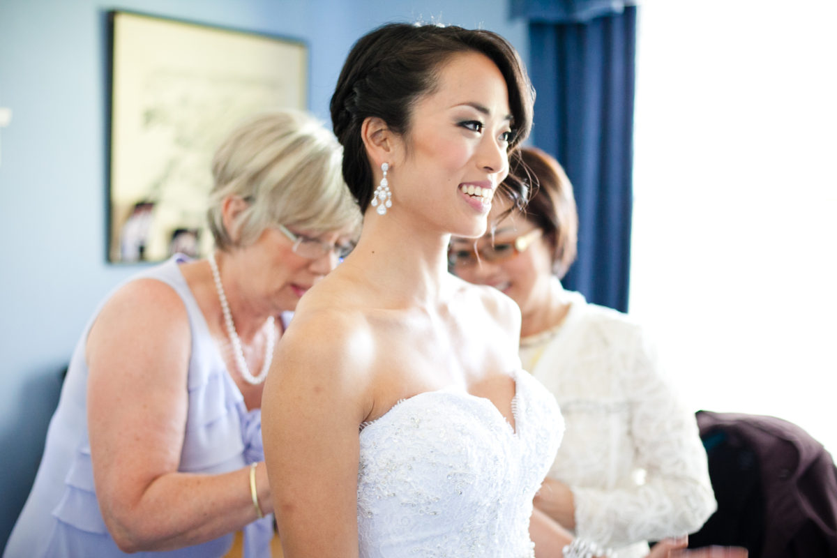 getting ready photos, bride, mothers helping with wedding dress