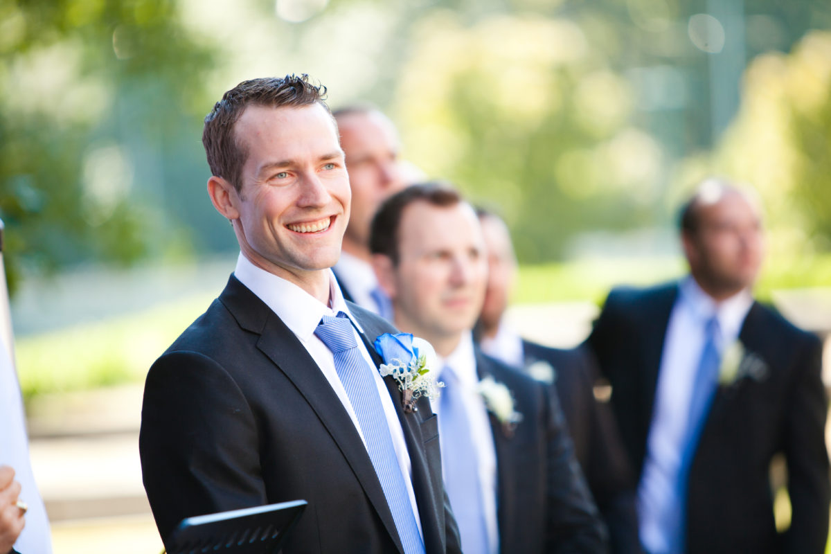 groom excited as bride comes down the aisle, first look