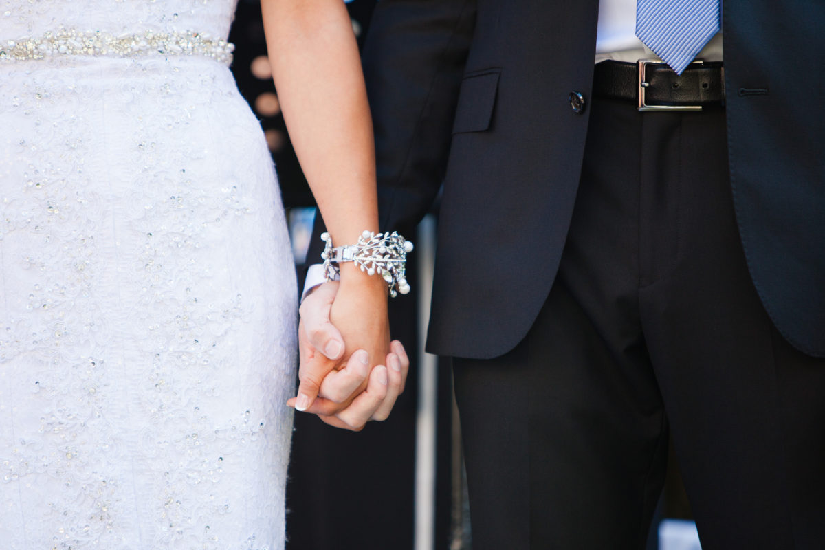 wedding ceremony detail couple holding hands