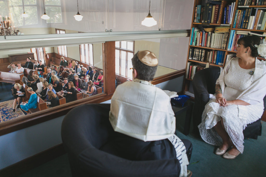 couple looks down on the guests at vancouver jewish wedding