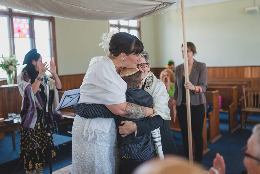 couple hugging son after wedding ceremony vancouver