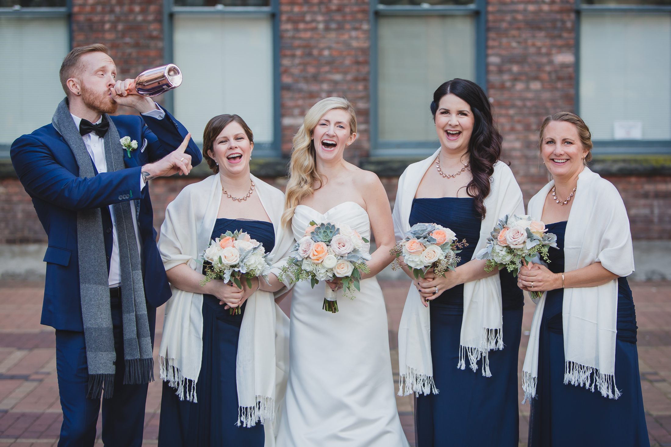 urban wedding party photo in yaletown vancouver, drinking champagne