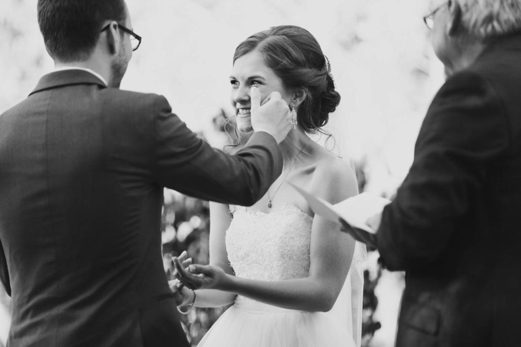 bride crying during ceremony at secret garden at woodbridge ponds in abbotsford wedding