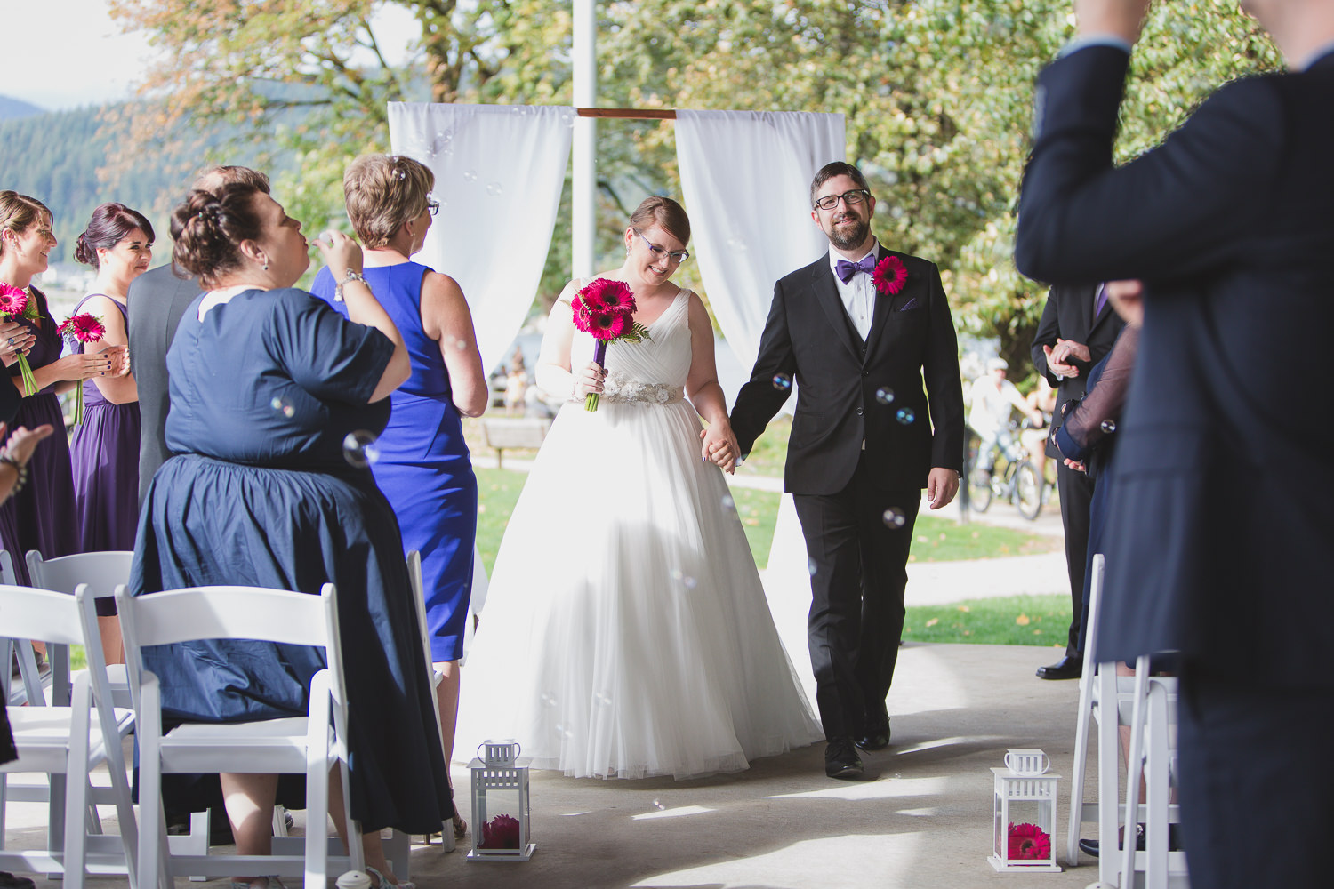 newly married couple leaving wedding ceremony at rocky point park PCT stage