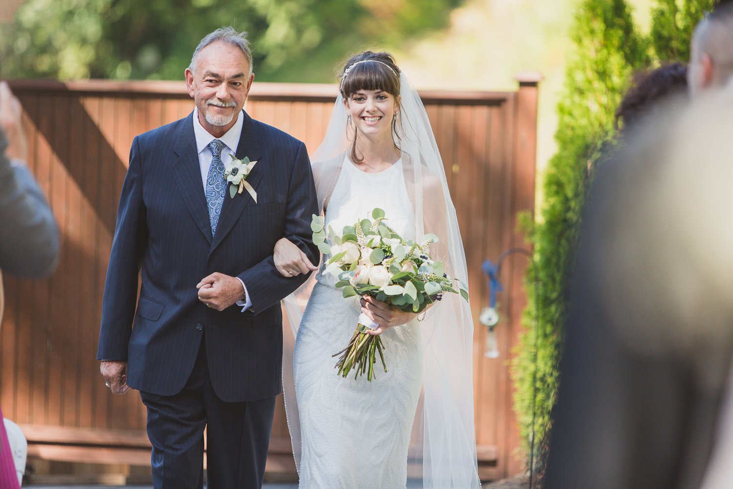 Bride coming down the aisle with dad at Sea to Sky wedding