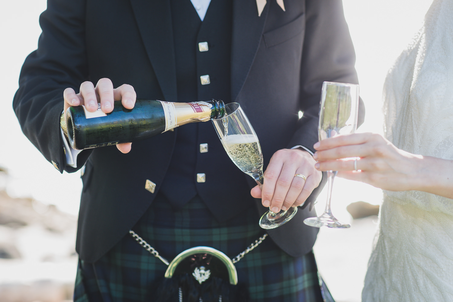 groom in kilt with champagne