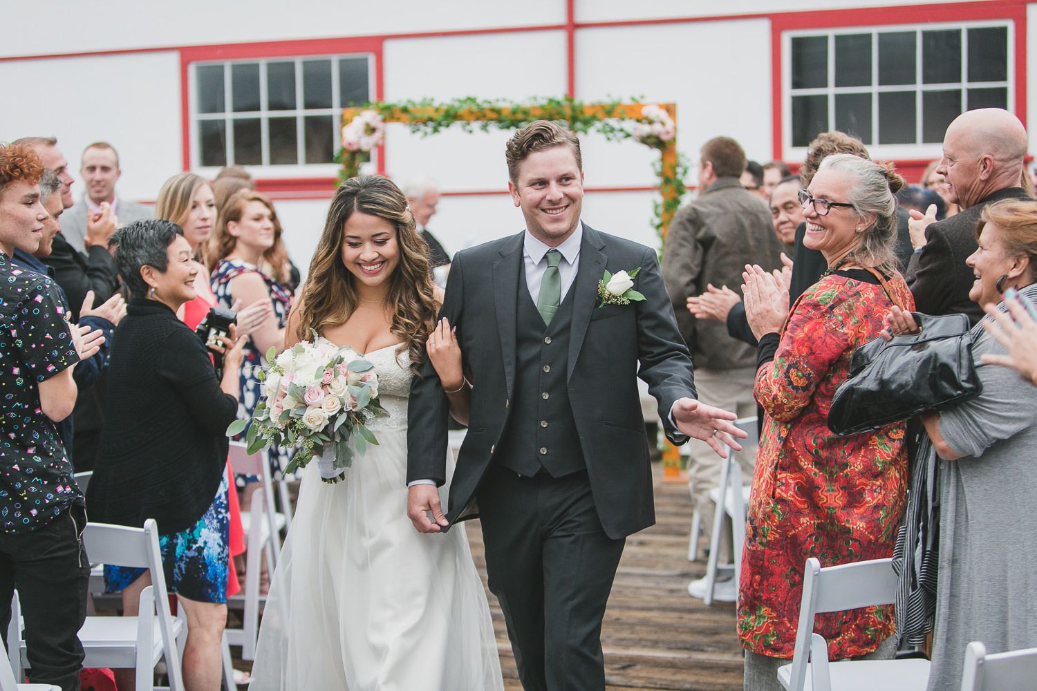 bride and groom recessional with crowd at quirky wedding