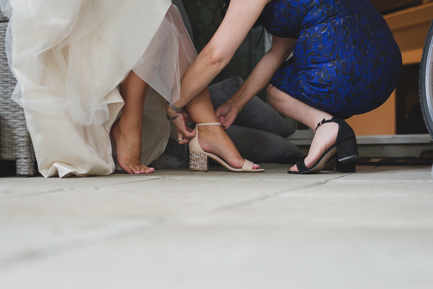 wedding getting ready photos, mom helping bride with wedding shoes