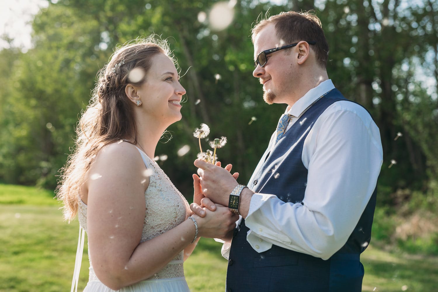 couple with dandelion seeds at vancouver elopement