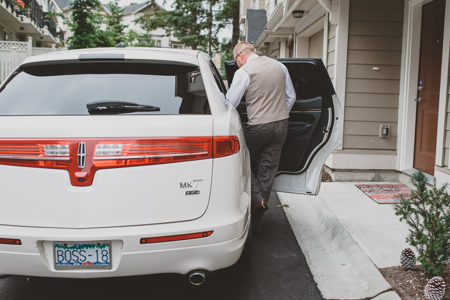 groom leaving for wedding in boss limousine