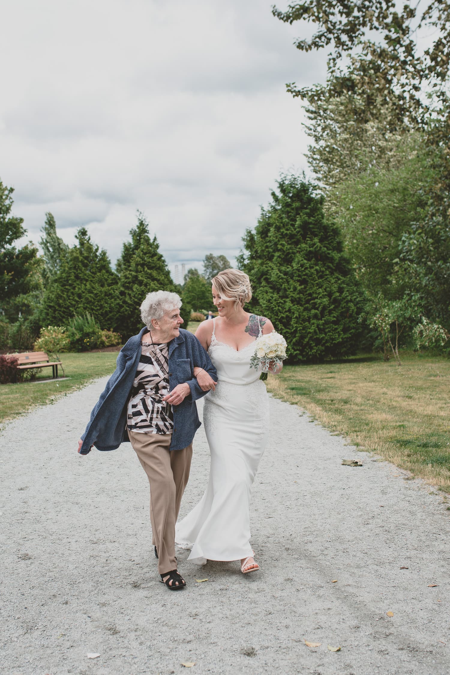 bride walking to wedding ceremony aisle with grandma in Osprey Village Pitt Meadows