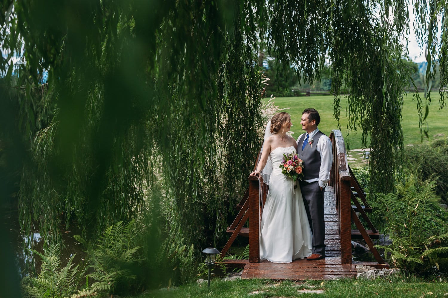 wedding couple portrait on bridge at Heronsbridge in abbotsford