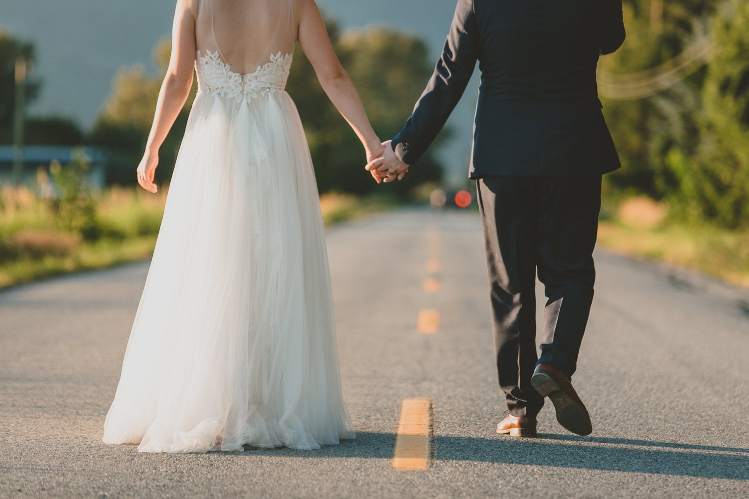Couple walking down road at pitt meadows barn wedding