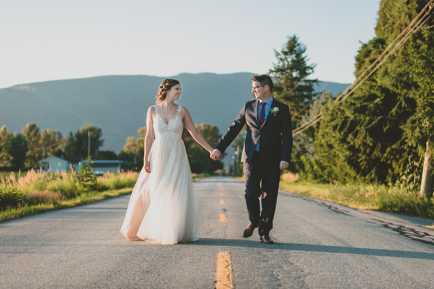 couple walking down road at hopcott farms wedding in pitt meadows