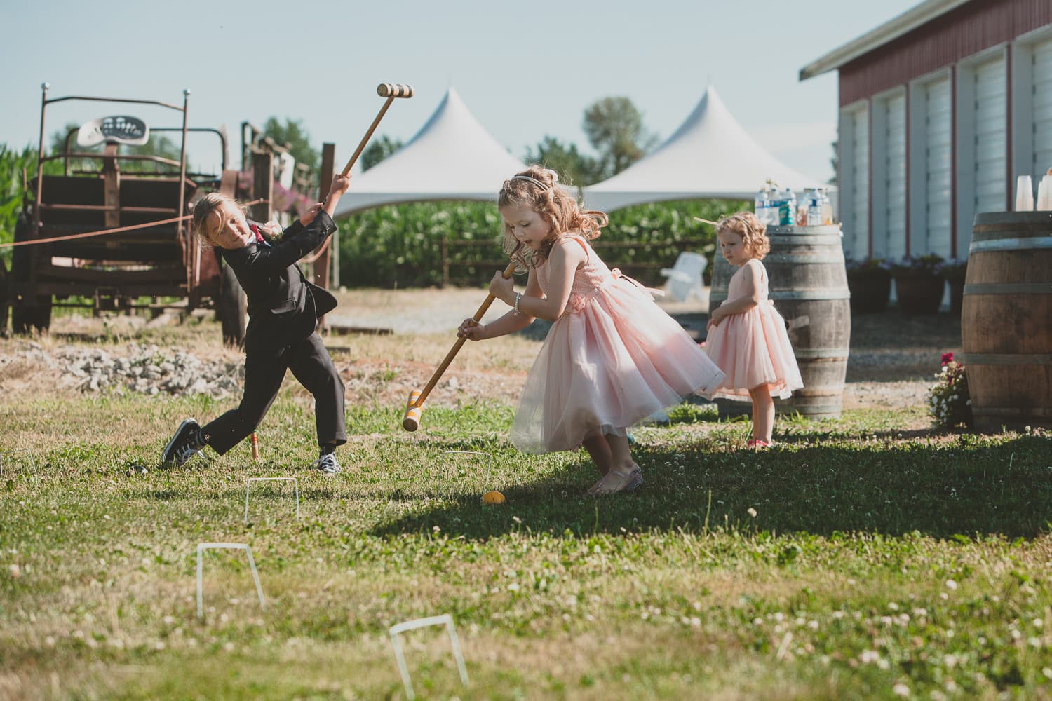 candid photo of kids playing croquet at farm wedding in pitt meadows