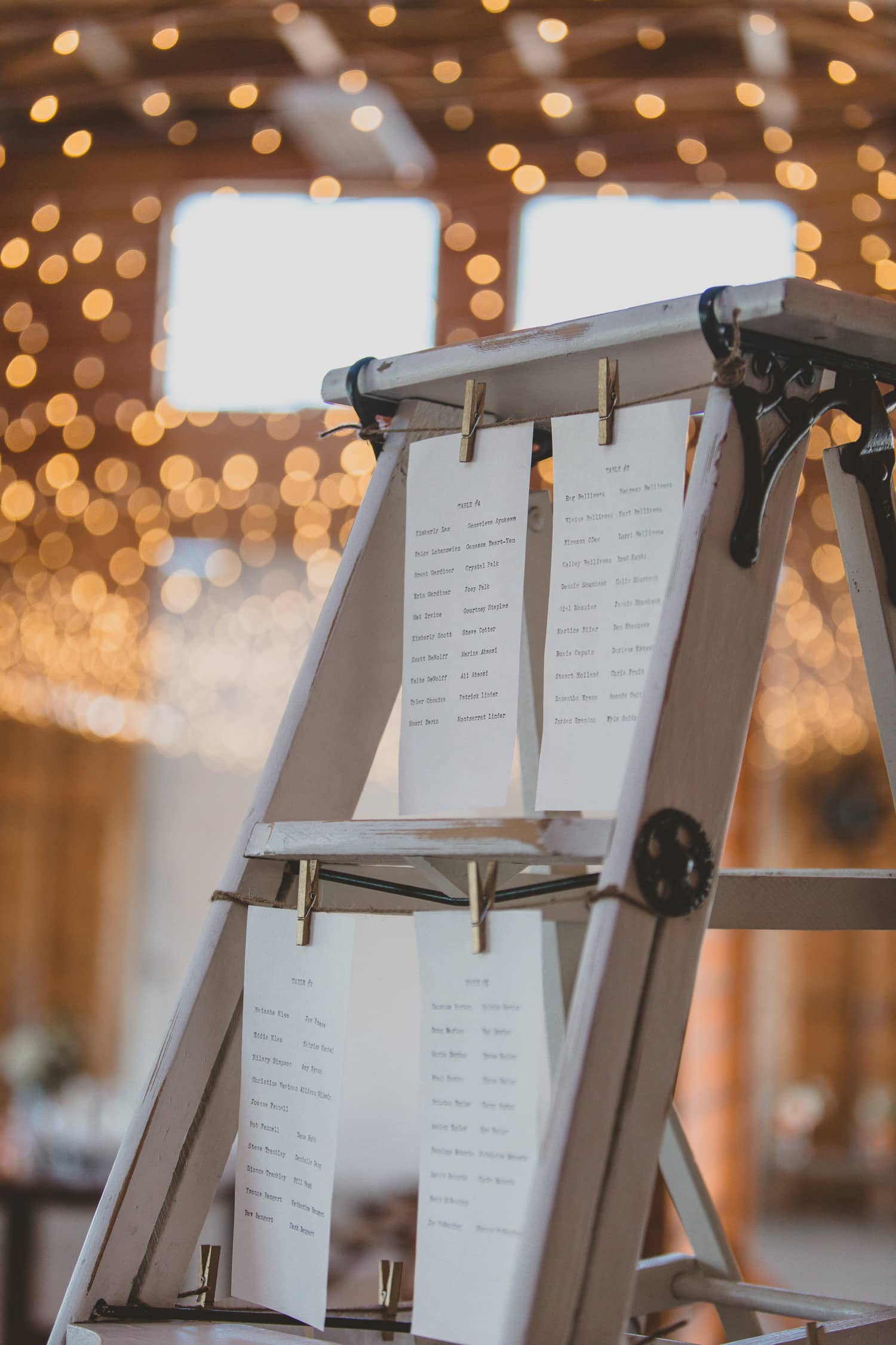 rustic ladder seating chart idea with names written on typewriter