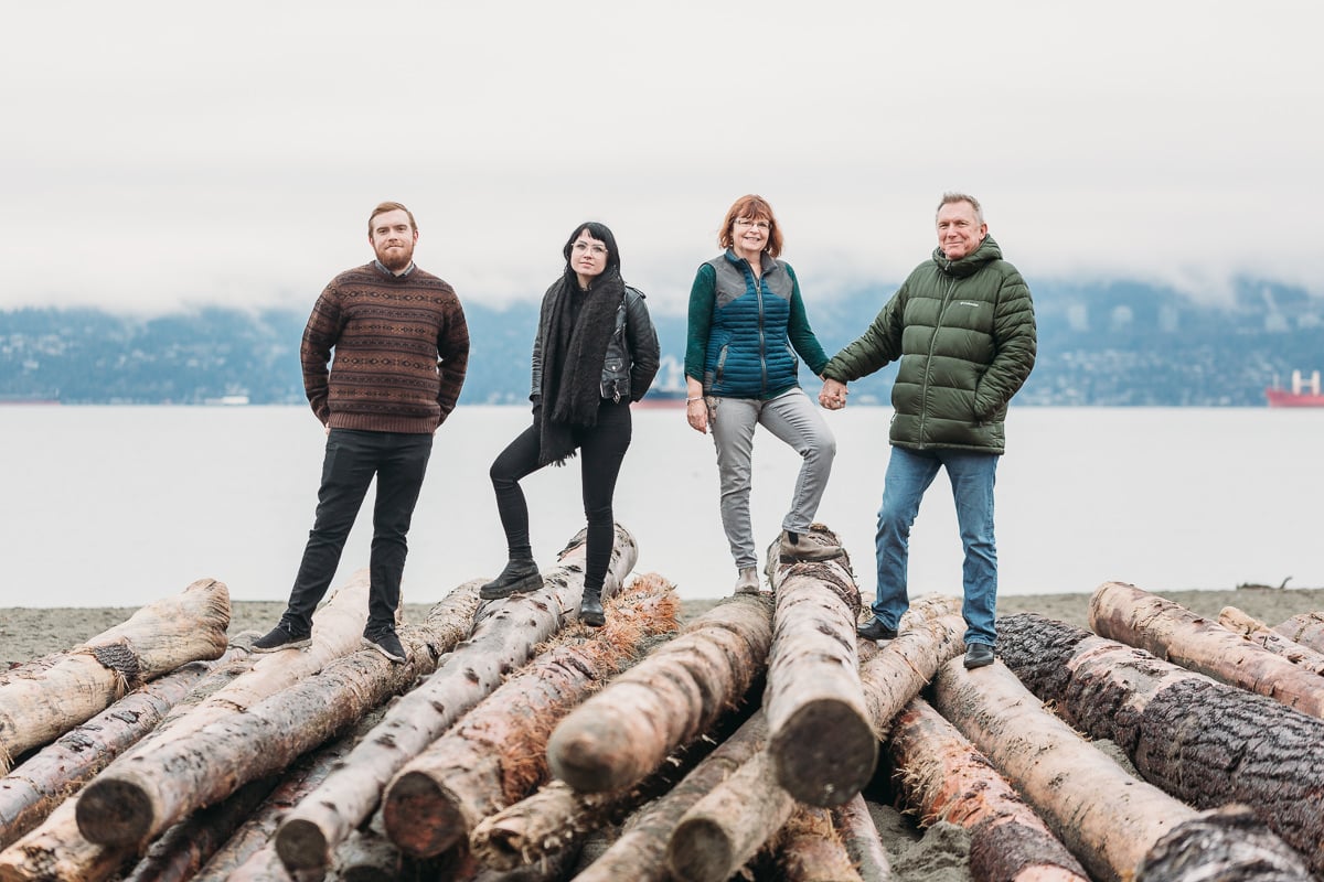 family photography with adult kids in vancouver on logs at jericho beach
