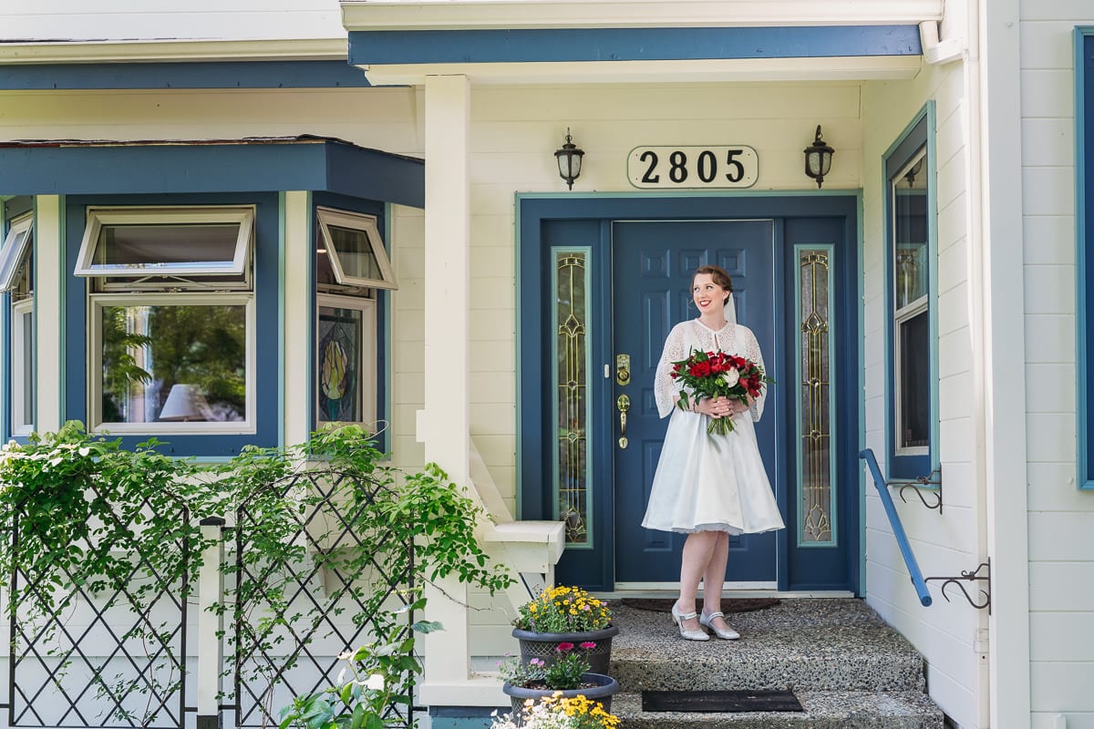 bride posing at childhood home on wedding day