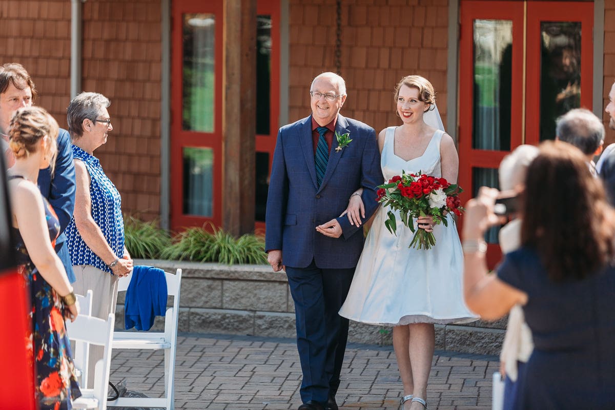 bride and father walking down the aisle at wedding ceremony