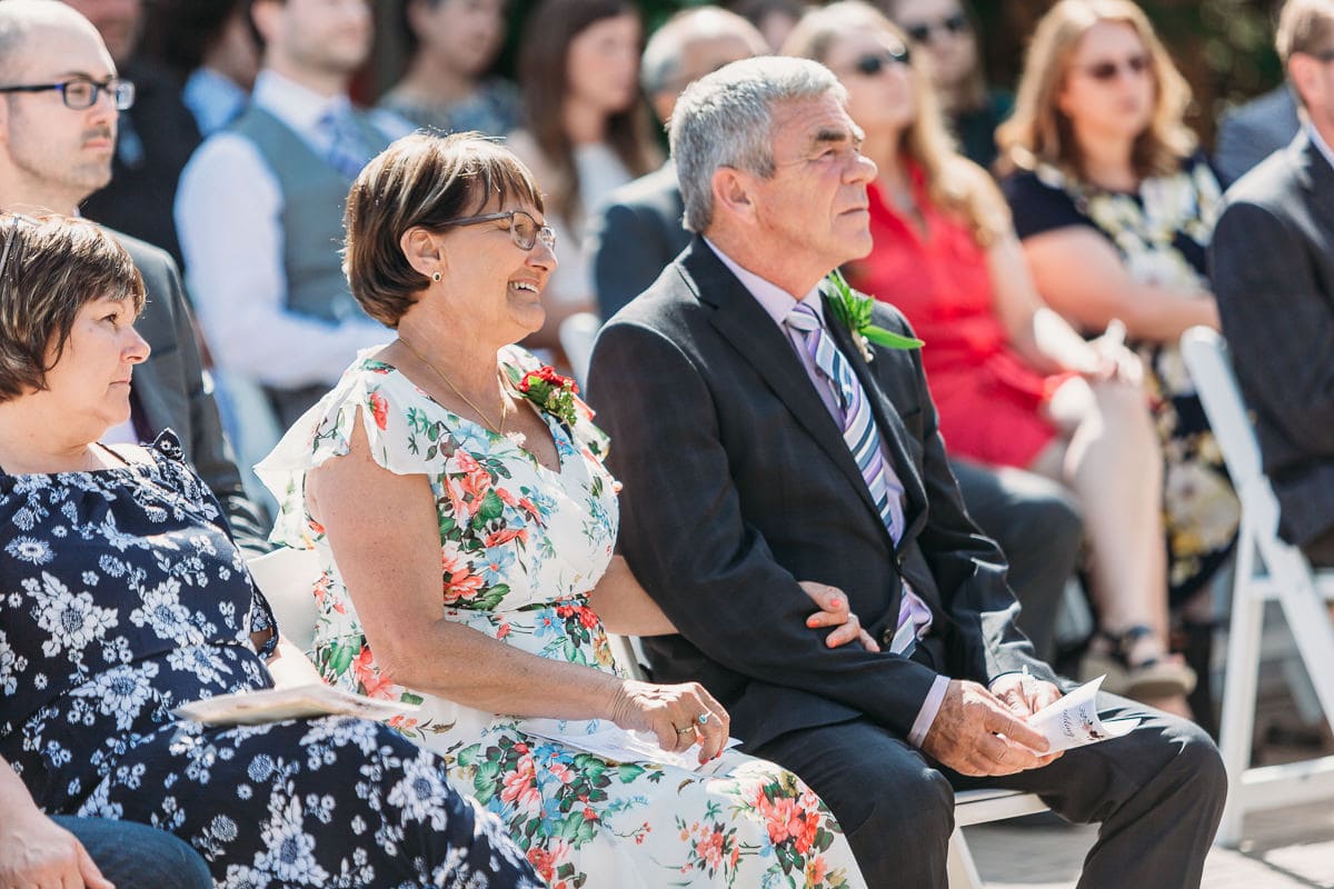 groom's parents watching wedding ceremony