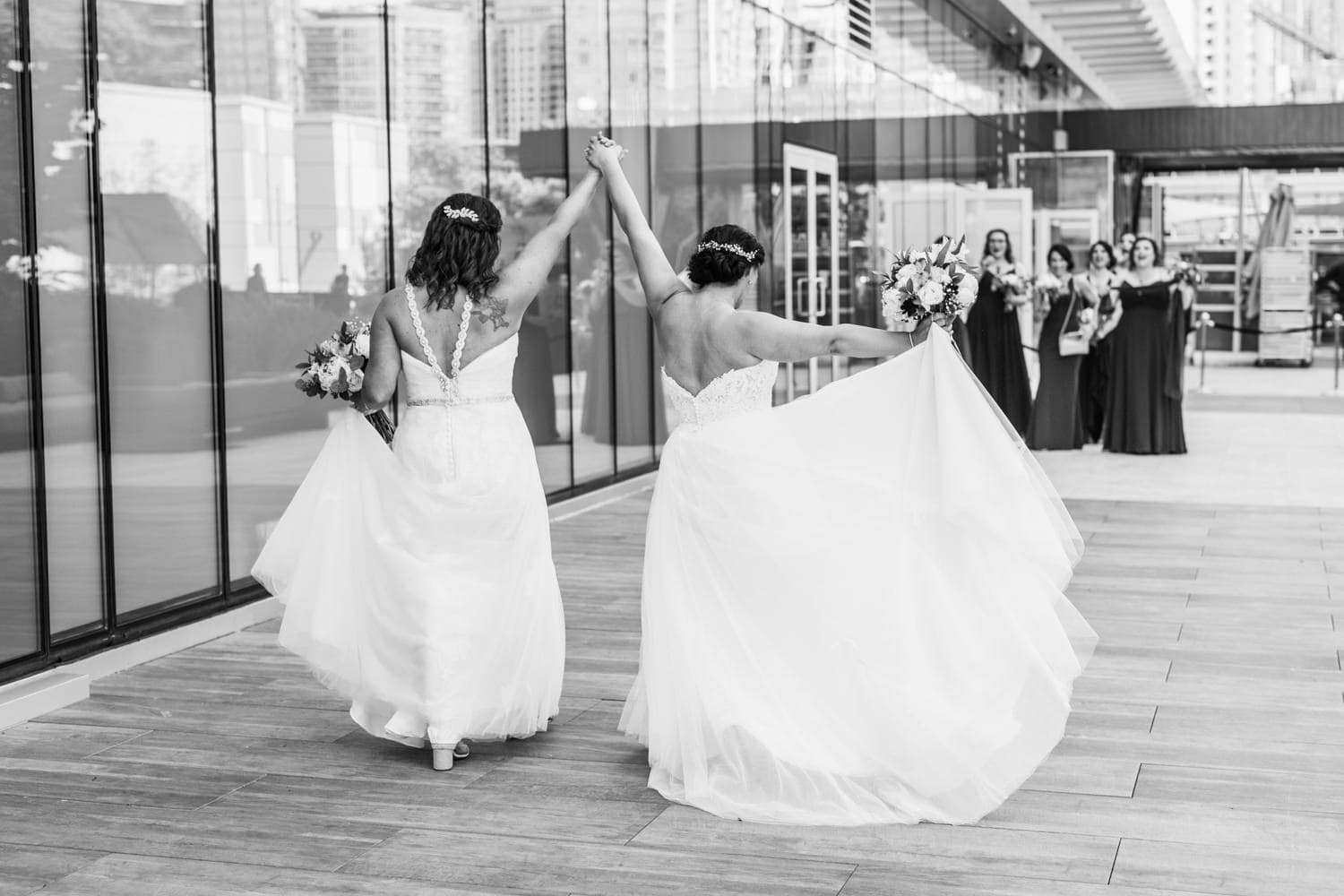 two excited brides at lgbtq wedding at parq hotel vancouver