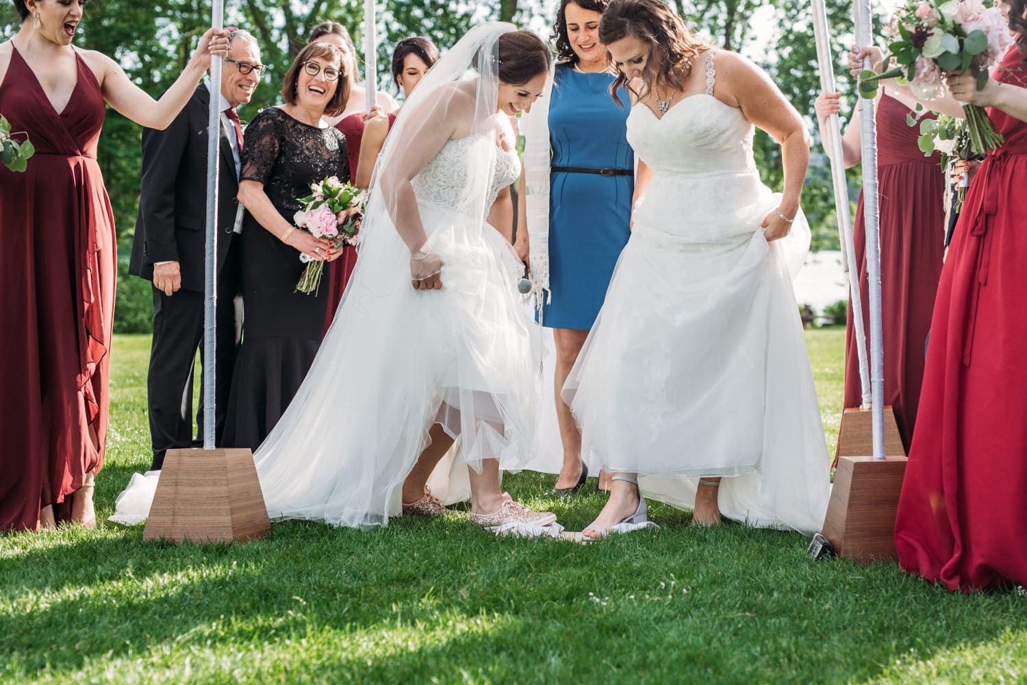 two brides breaking the glass at jewish lgbtq wedding in vancouver
