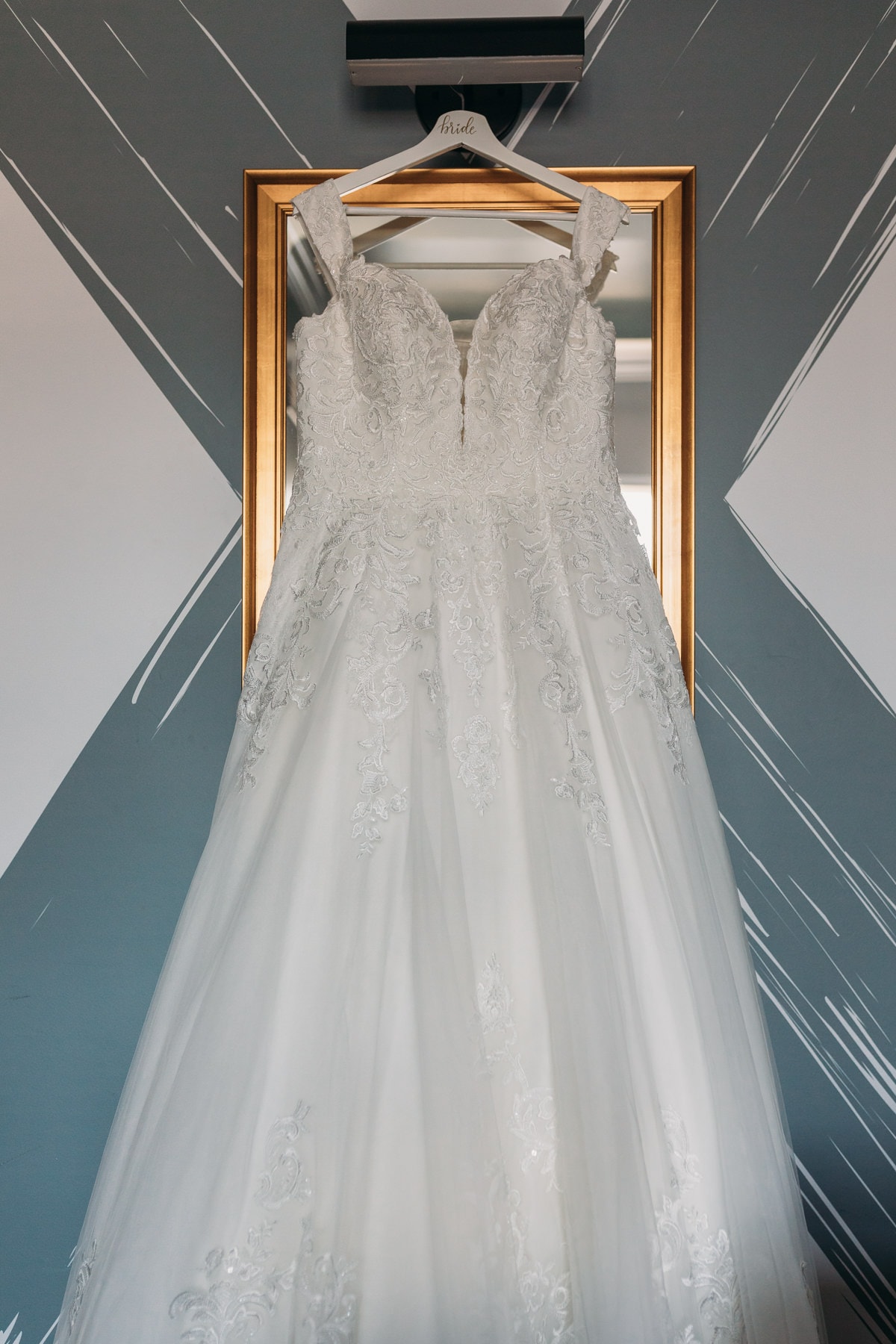 wedding dress hanging at hotel belmont