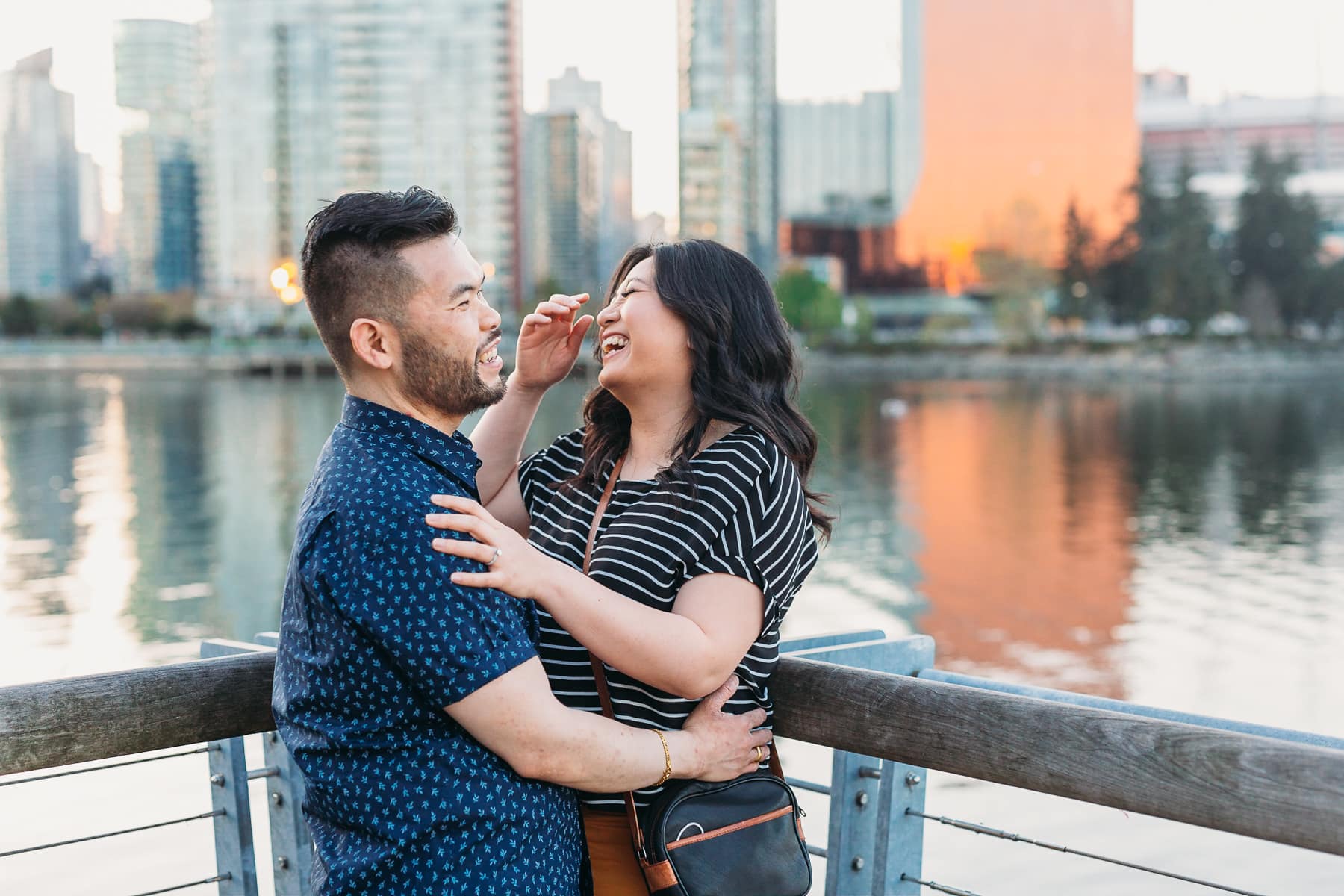 couple laughing at olympic village vancouver engagement session