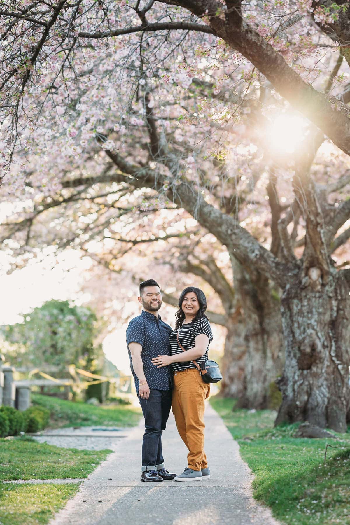 casual fun engagament photos in Vancouver cherry blossoms
